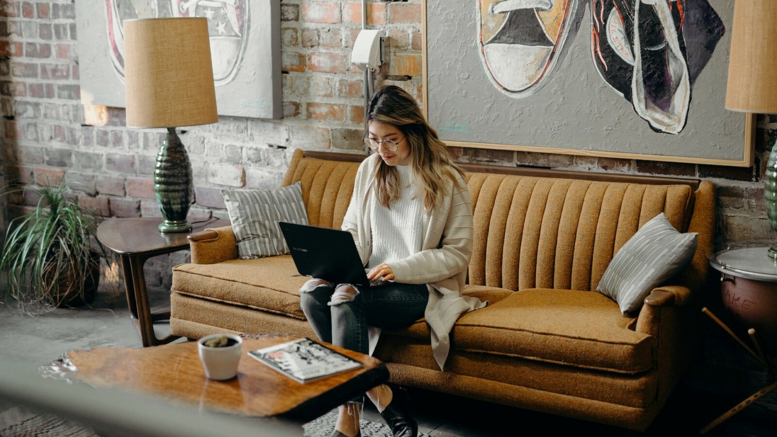 a remote worker sitting on a couch with a laptop