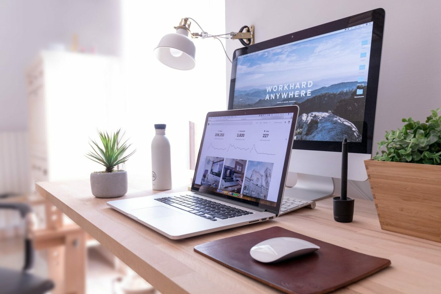 two computers screens set up on a desk for remote work